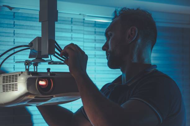 man installing a home theater projector